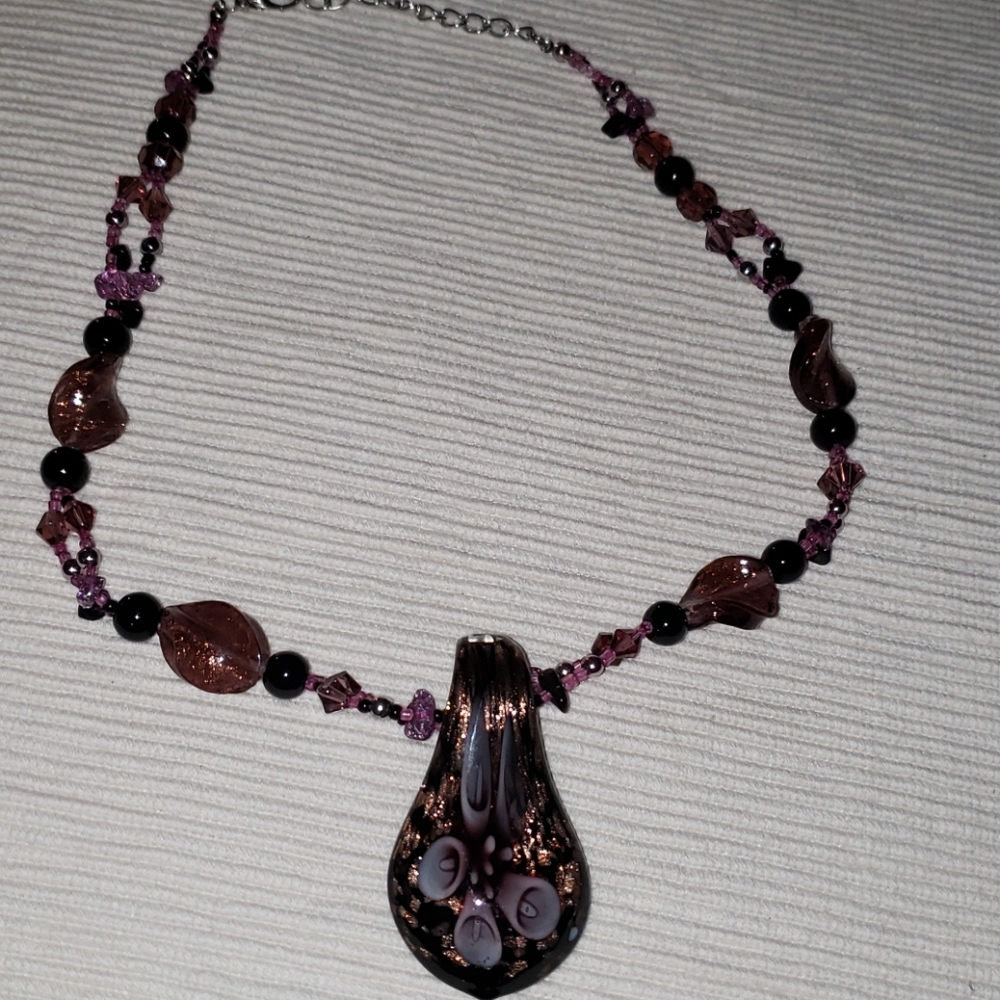 Beautiful bead necklace with purple flower pendant